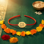 Bazinco Premium Oval Ganpati Symbol Gold Finish Designer Rakhi